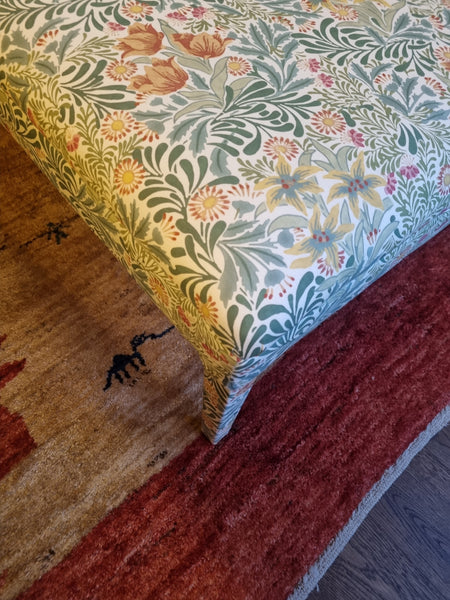 RETURNED PRODUCT An XL Ottoman with upholstered legs in Morris and Co