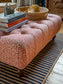 Our buttoned ottoman is handmade in the UK