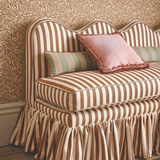 Lila wavy back banquette, set with cushions and striped fabric by romo