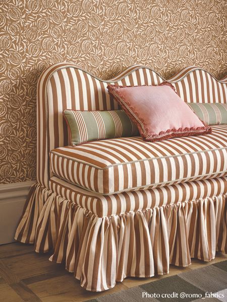 Lila wavy back banquette, set with cushions and striped fabric by romo