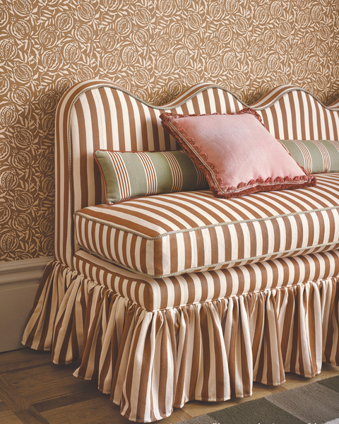Lila wavy back banquette, set with cushions and striped fabric by romo