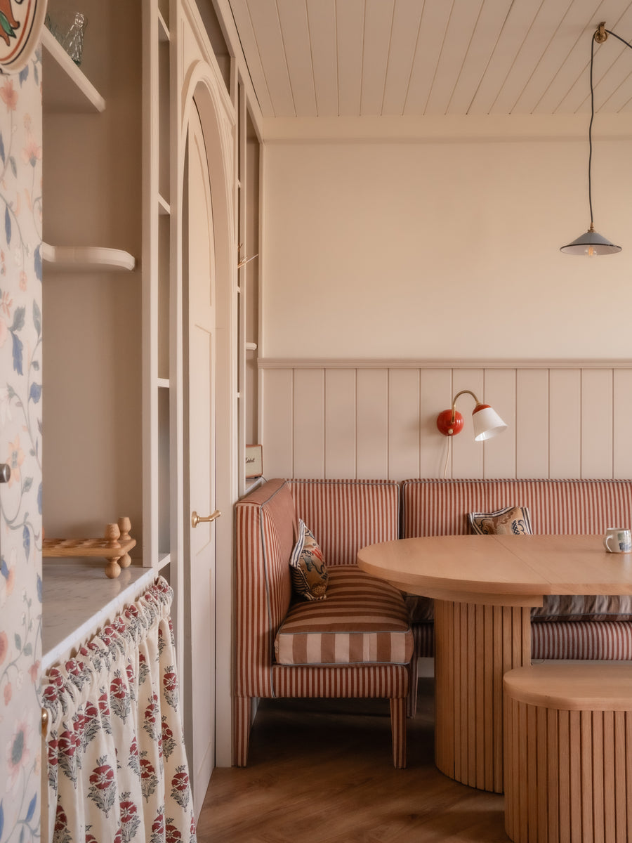 Banquette in dining room setting, with striped fabric