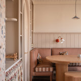 Banquette in dining room setting, with striped fabric