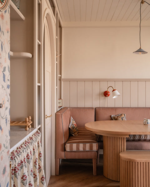 Banquette in dining room setting, with striped fabric