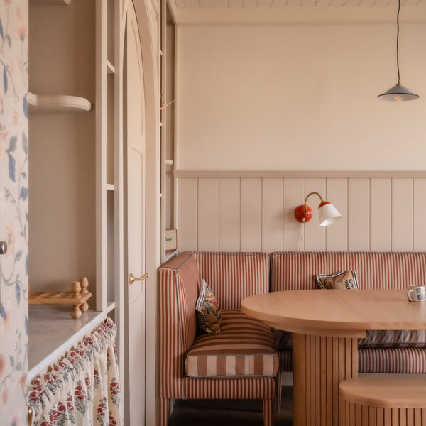 Banquette in dining room setting, with striped fabric