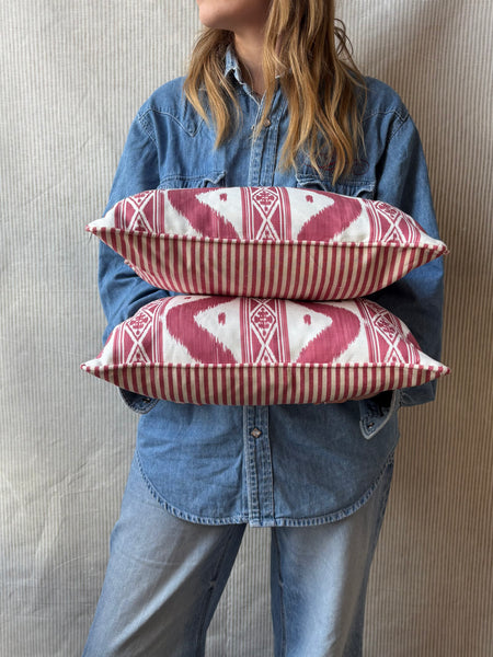 A pair of Mrs Alice, Ikat stripe in raspberry with Candy stripe red back and piping Lumbar cushion 30 x 40cm
