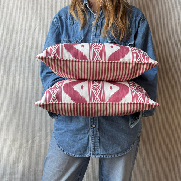 A pair of Mrs Alice, Ikat stripe in raspberry with Candy stripe red back and piping Lumbar cushion 30 x 40cm