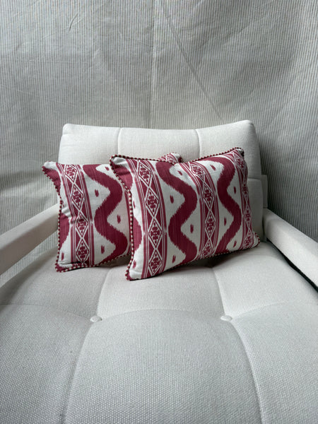 A pair of Mrs Alice, Ikat stripe in raspberry with Candy stripe red back and piping Lumbar cushion 30 x 40cm