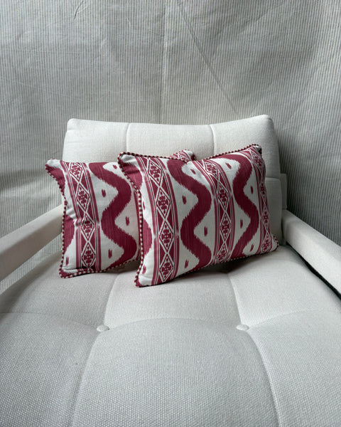 A pair of Mrs Alice, Ikat stripe in raspberry with Candy stripe red back and piping Lumbar cushion 30 x 40cm