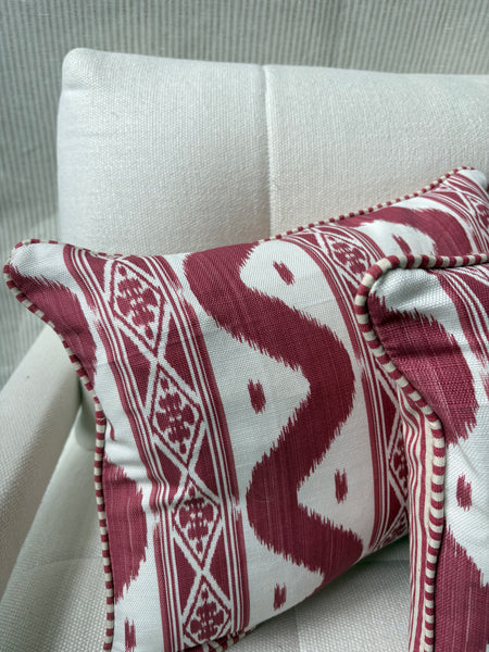 A pair of Mrs Alice, Ikat stripe in raspberry with Candy stripe red back and piping Lumbar cushion 30 x 40cm