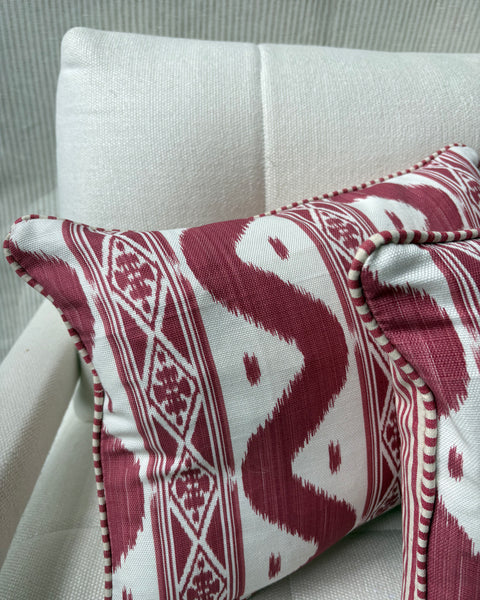 A pair of Mrs Alice, Ikat stripe in raspberry with Candy stripe red back and piping Lumbar cushion 30 x 40cm