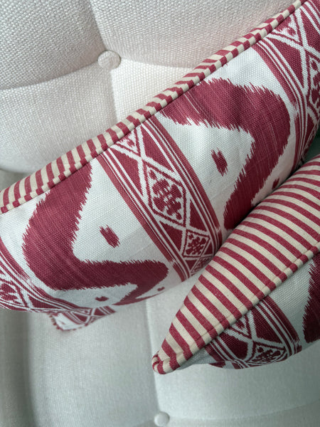 A pair of Mrs Alice, Ikat stripe in raspberry with Candy stripe red back and piping Lumbar cushion 30 x 40cm