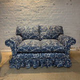 The Rhea skirted sofa styled in an multiple fabric colour way