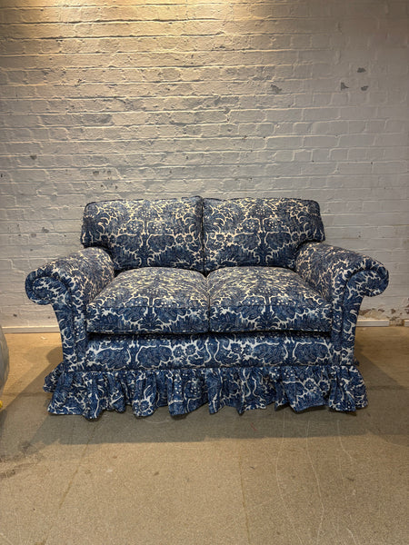 The Rhea skirted sofa styled in an multiple fabric colour way