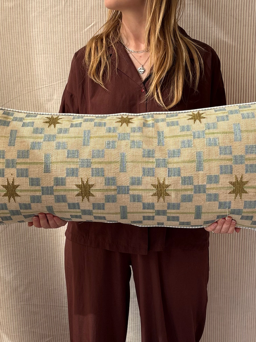 Bolster cushion 90 x 35cm in Studio Ashby, Afua in Olive with Blue stripe back and piping