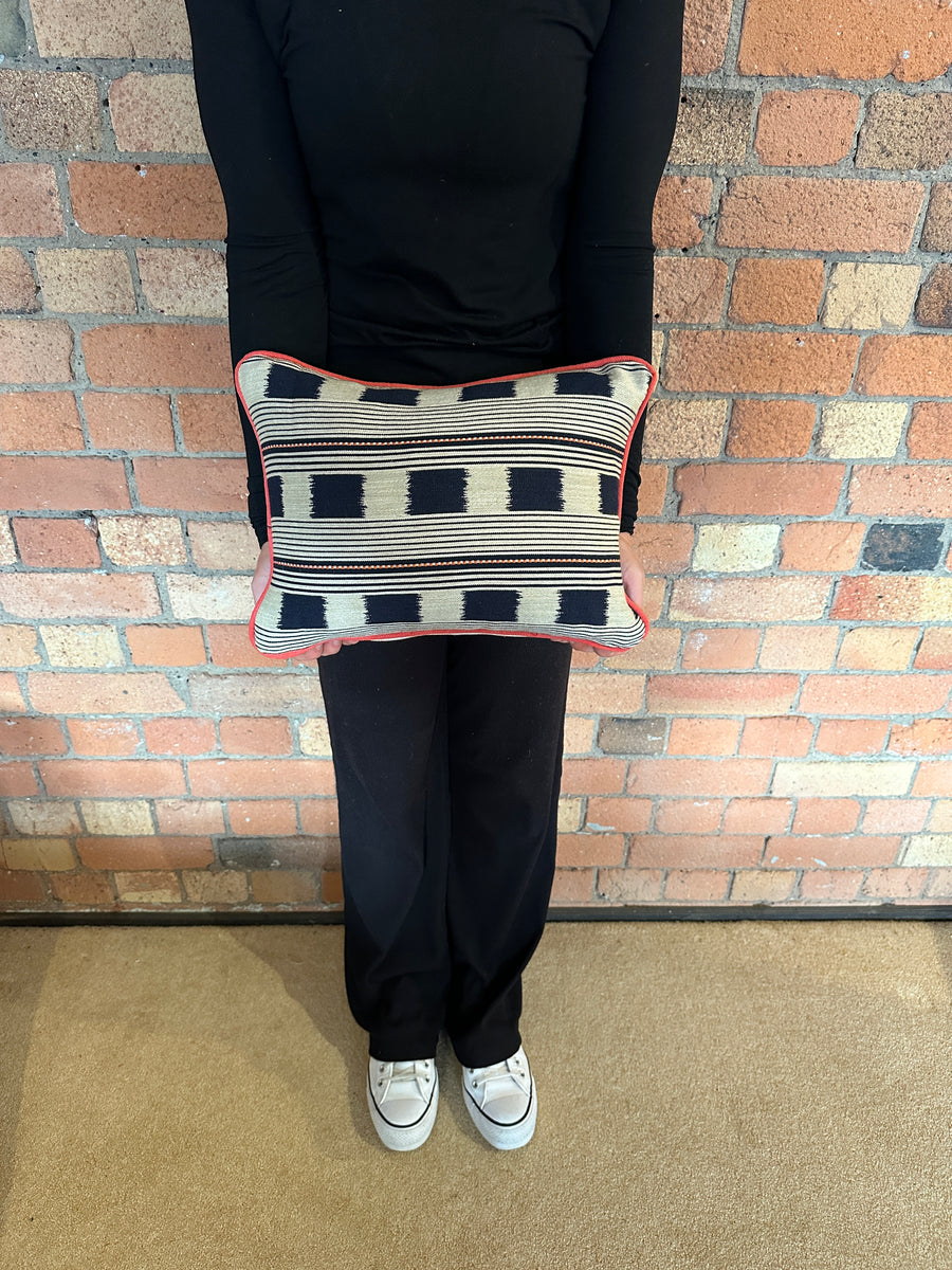 Lumbar cushion in Christopher Farr Lost and found Indigo with red piping