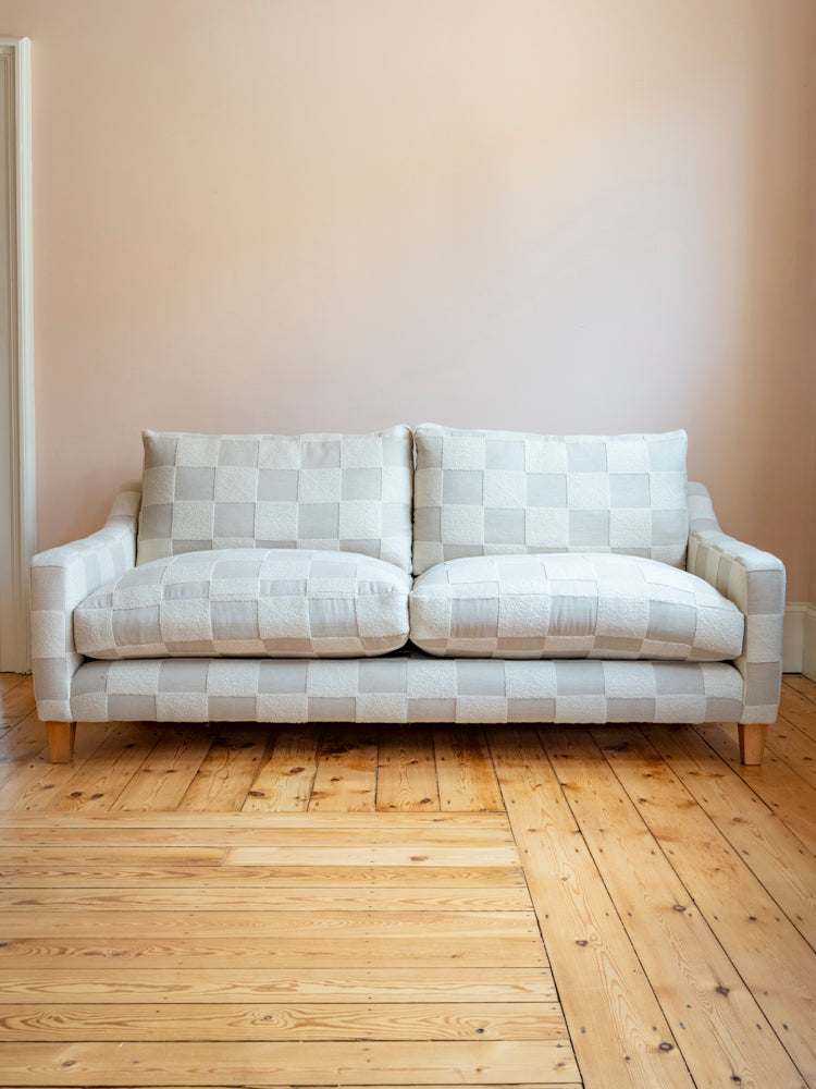 Our Chloe handmade sofa against a pink wall