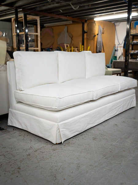 A skirted sofa in white