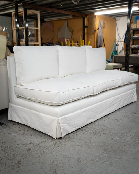 A skirted sofa in white