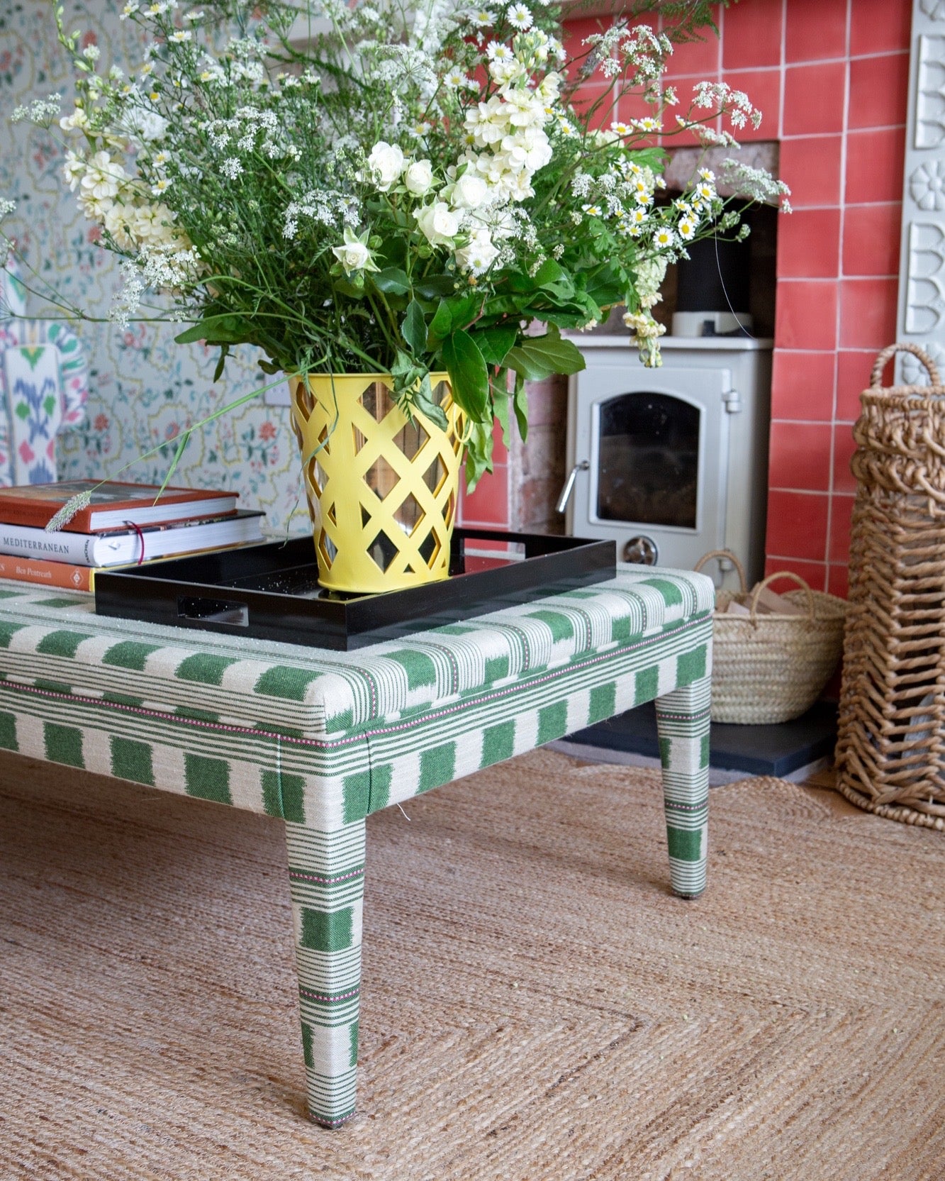 A close up view of a Honey coffee table in Green Christopher Farr Lost & Found fabric in a victorian style living room