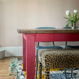 An Aria in Claremont Bon Marche Leopard print used as a dining bench