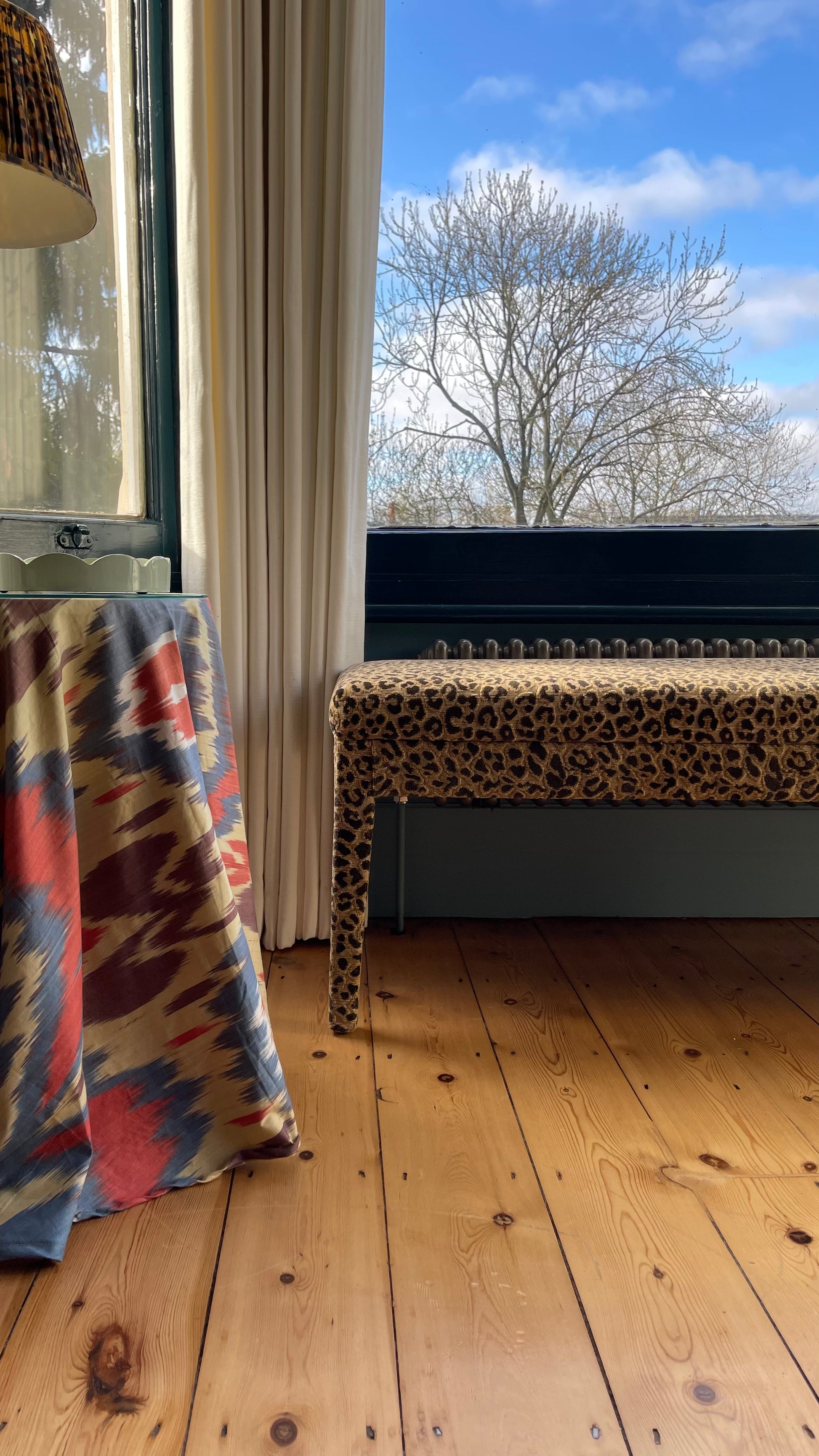 An Aria bench in Claremont Bon Marche Leopard print used as a window seat
